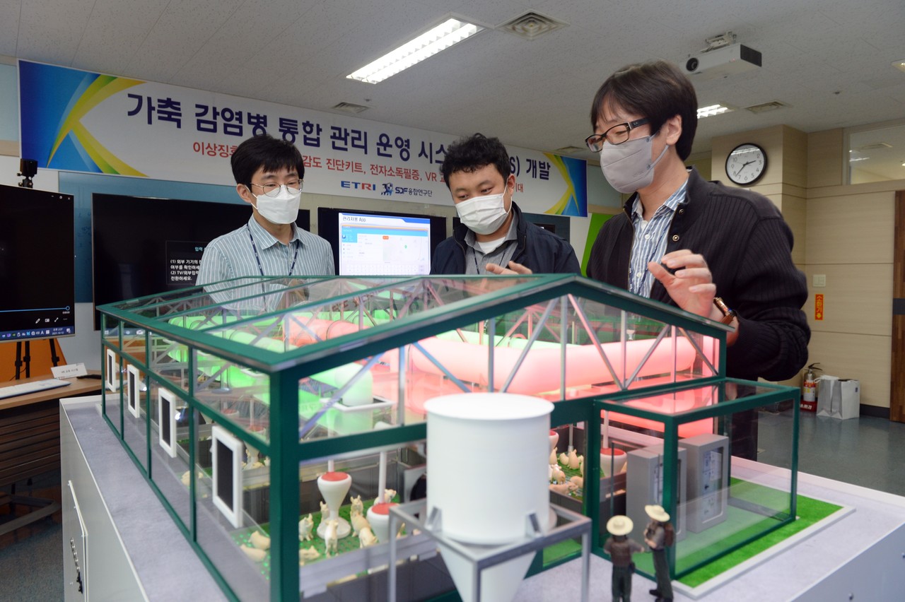 (왼쪽부터) 김대회, 이동규, 류진화 ETRI 선임연구원이 스마트 축사 모형 앞에서 가축 전염병 통합 관리를 위한 기술 적용을 논의하고 있다